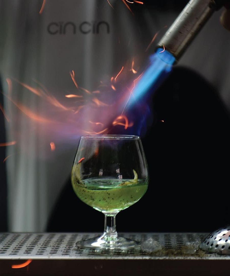 bartender lighting up a cocktail 